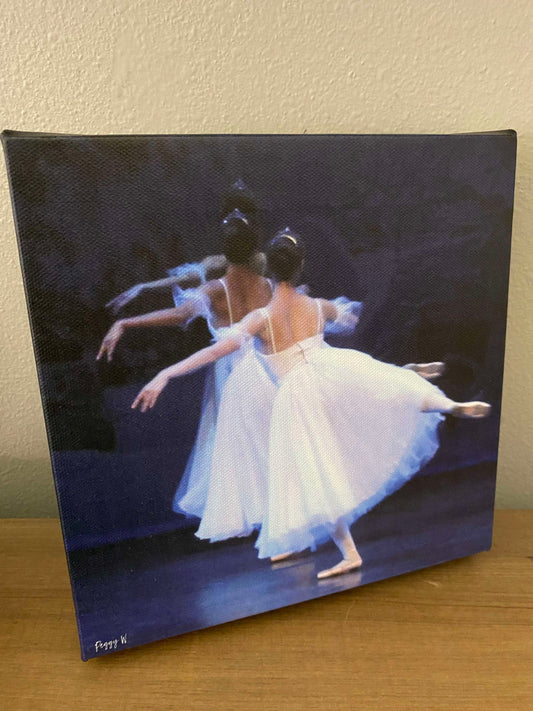 An oil painting of three ballet dancers from the rear dancing on stage in flowing white dresses printed on canvas