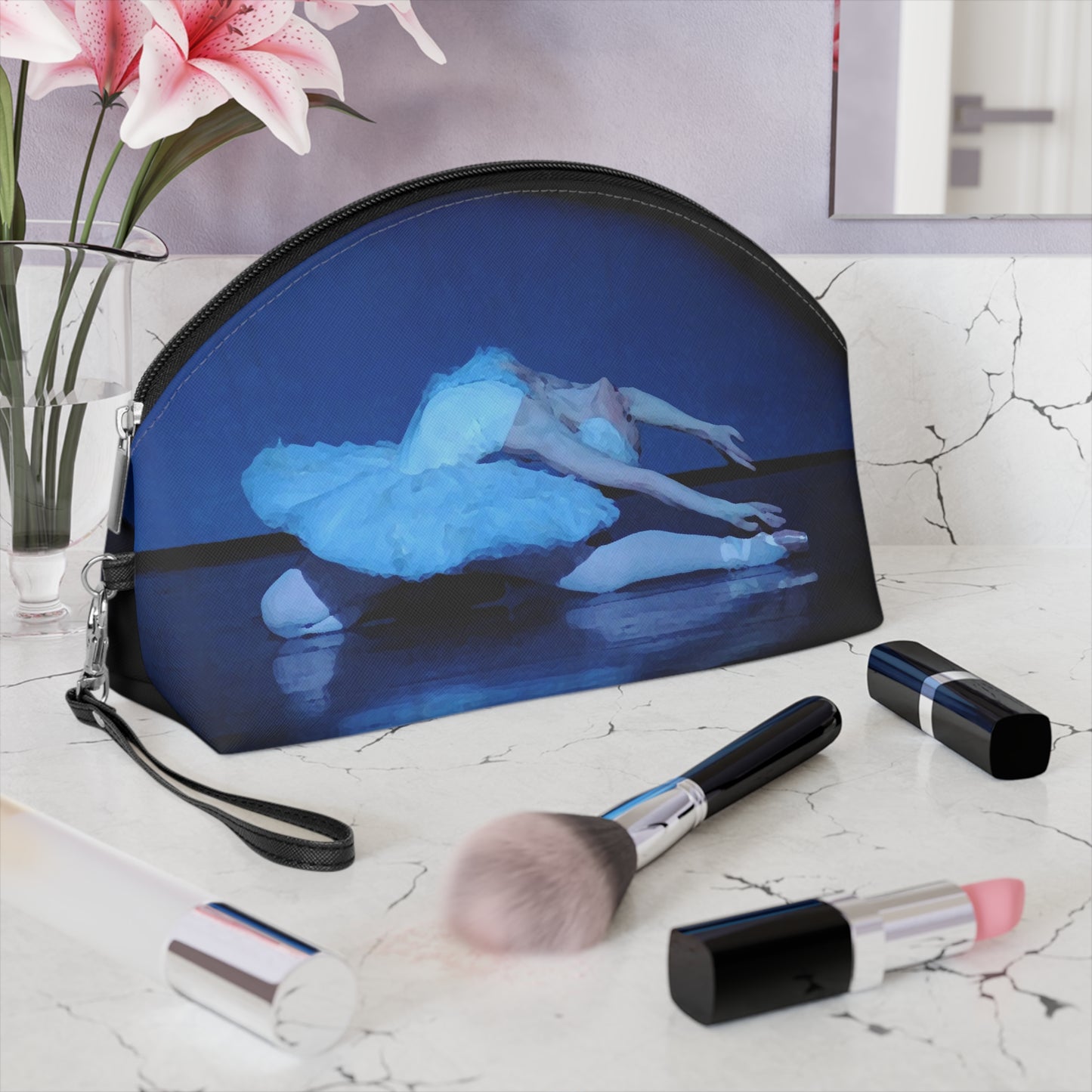 Prima ballerina performing the dying swan dressed in a white tutu bathed in blue light on a black background on a makeup bag.