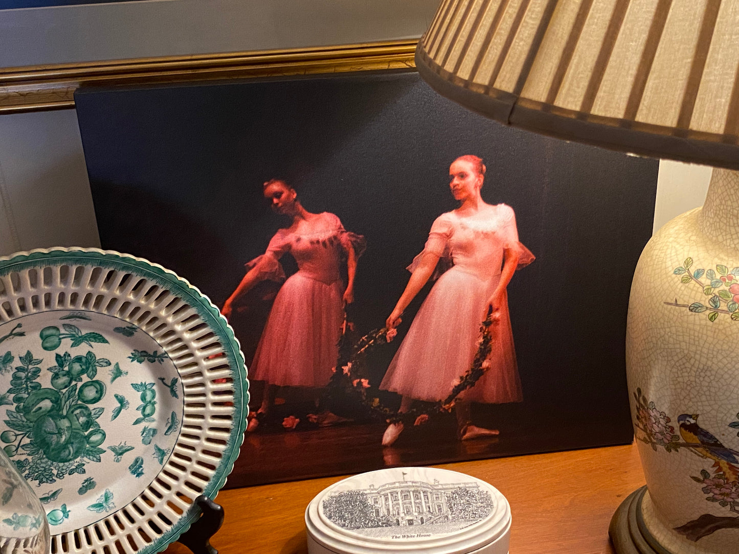 oil painting of ballerinas in pink displayed in a home setting
