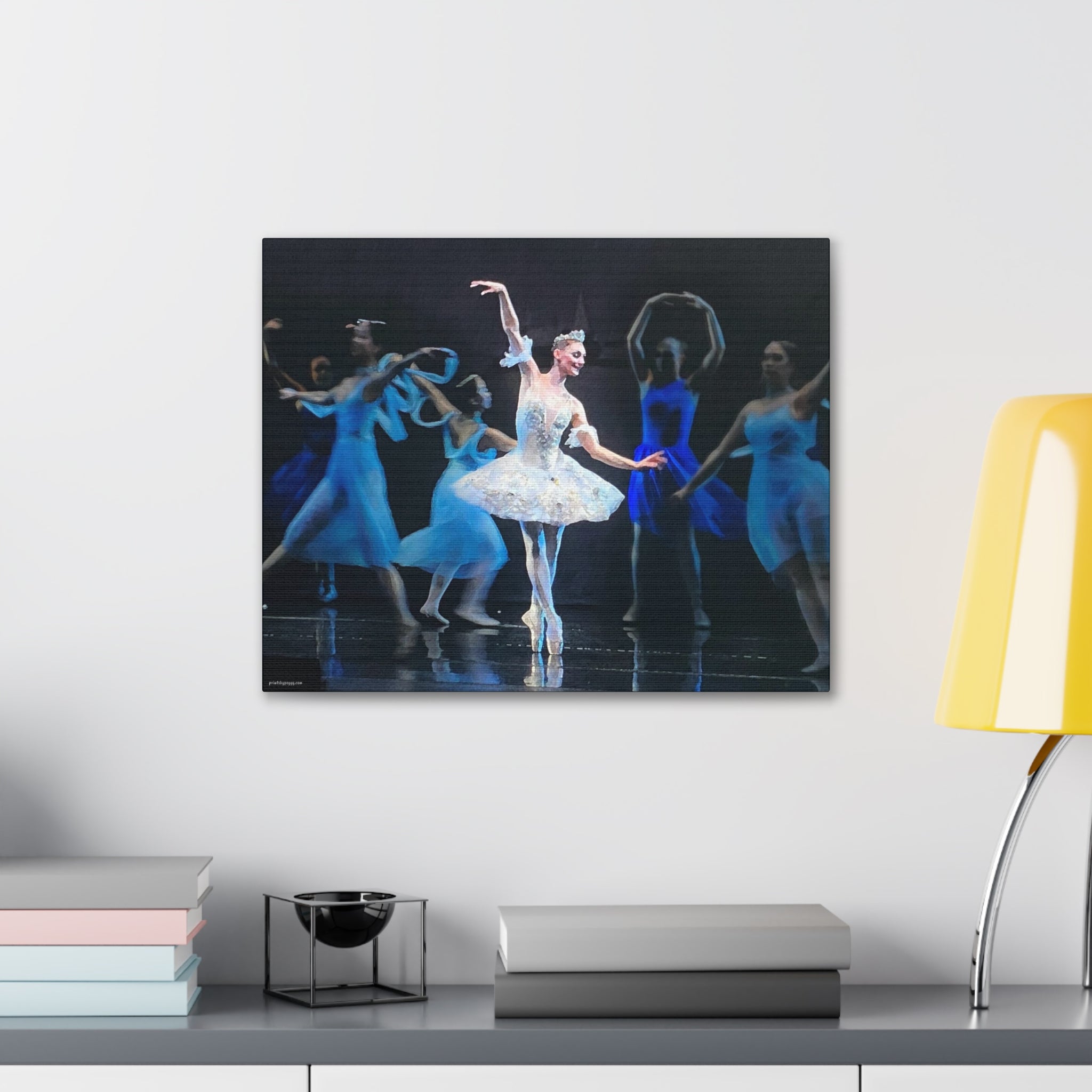 Canvas hanging on a wall over a desk of a Prima Ballerina surrounded by dancers in blue costumes