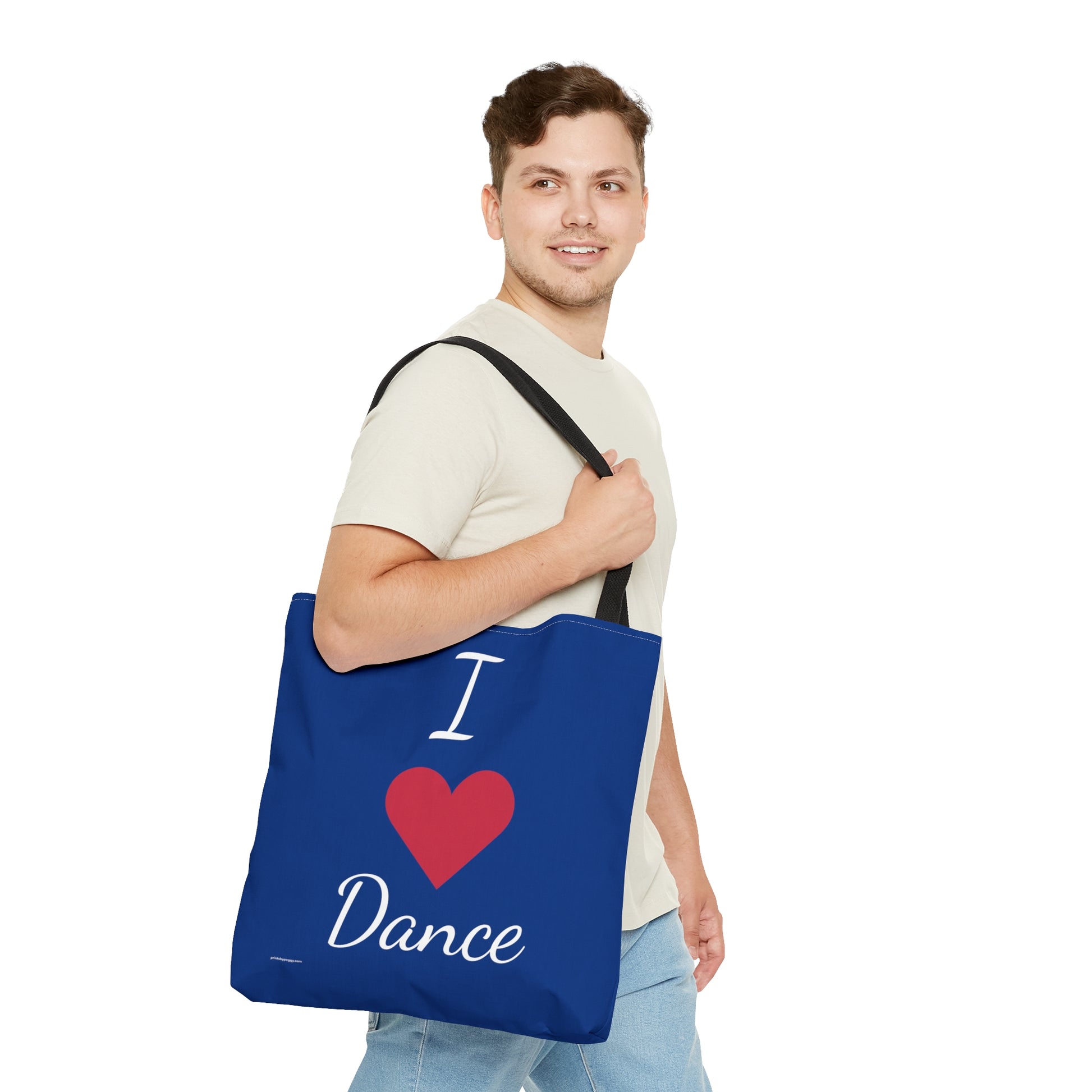 Dancer holding the bright blue Dance tote bag that has I heart dance written on it.