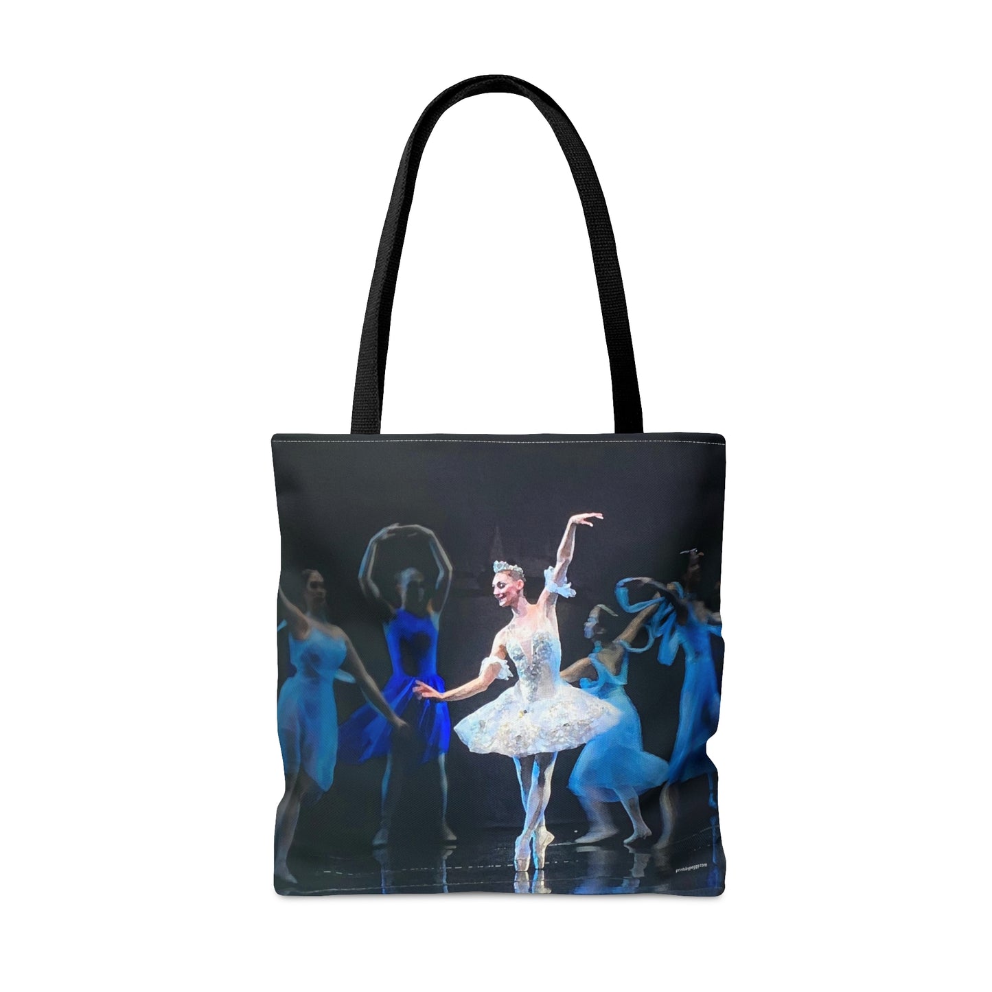 Reverse side of dance tote bag with ballerinas dancing on stage in blue costumes around a ballerina in white opposite side of bag is text. Handles are black.