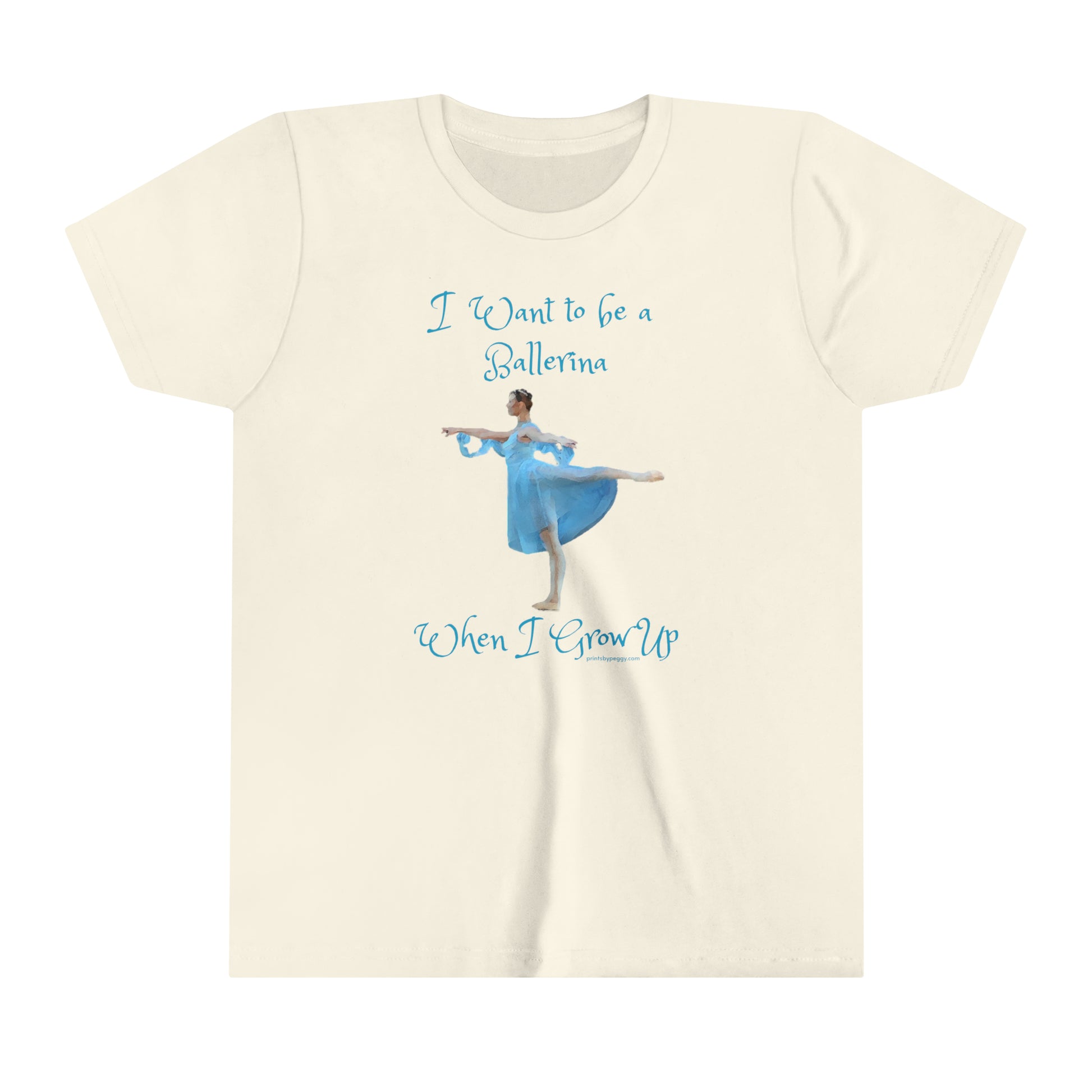 Front view of a cream colored t-shirt with a ballerina wearing light blue costume pictured and I want to be a ballerina when I grow up written in teal blue