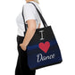 I love Dance written on a black dance tote bag. Heart is a red heart instead of writing. Hints of blue on black background, black straps.