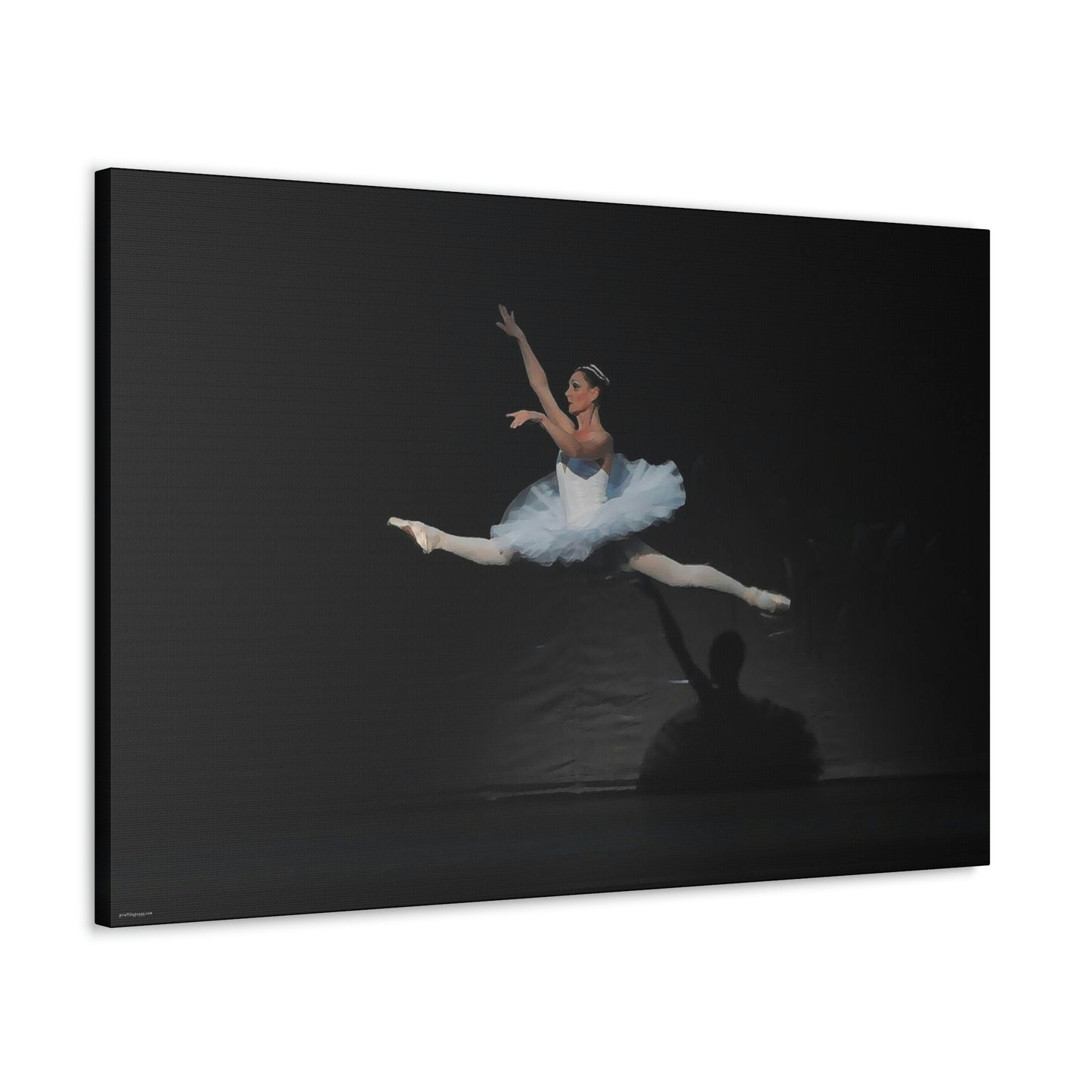 Canvas print hanging on white wall of Ballerina in a white tutu in mid-air performing a leap. Background is black  