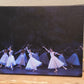 a photo of Artwork of Graceful ballet dancers in white dresses wearing tiaras performing on stage on a dark winter scene backdrop