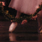 detail section of the painting showing ballerina feet and the pink rose wreathe