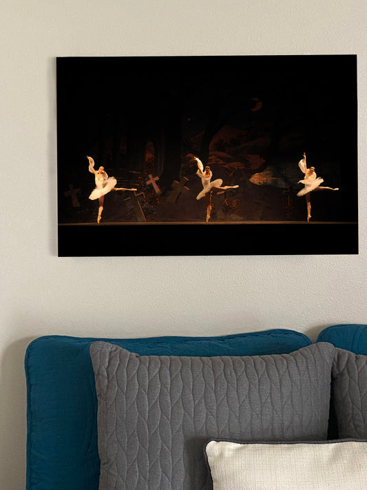 a painting on a wall of ballet dancers in white tutus on a dark background with crosses on it