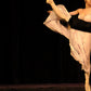 A closeup detain of the artwork of A kick line comprised of male and female dancers. Females are in white and the males are in tuxedos with top hats  