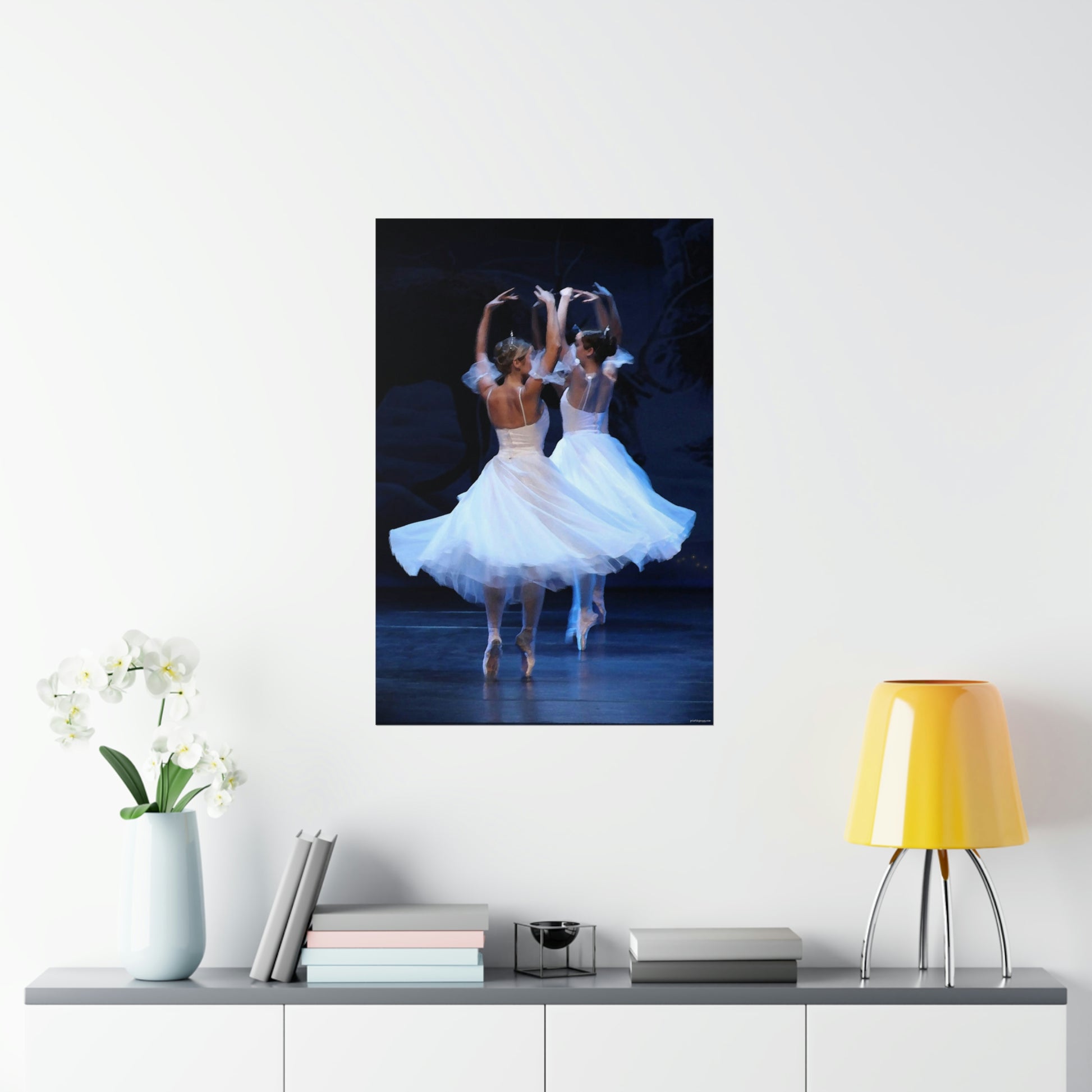 two ballerinas in white flowing costumes with a dark background on a premium matter poster.