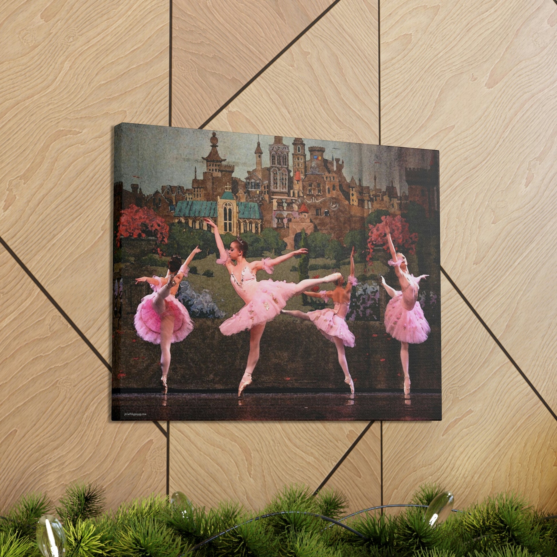 Canvas gallery wrap hanging on a wooden wall of Four ballerinas dancing in a circle on stage with a castle backdrop dressed in pink