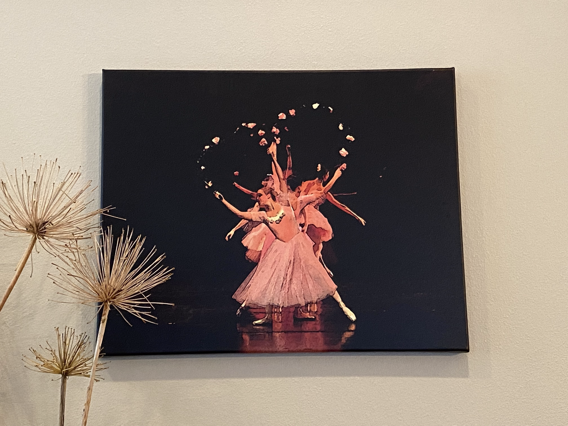 Painting of ballerinas on a dark stage dressed in pink