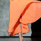 detail view of dancer on stage in orange costume