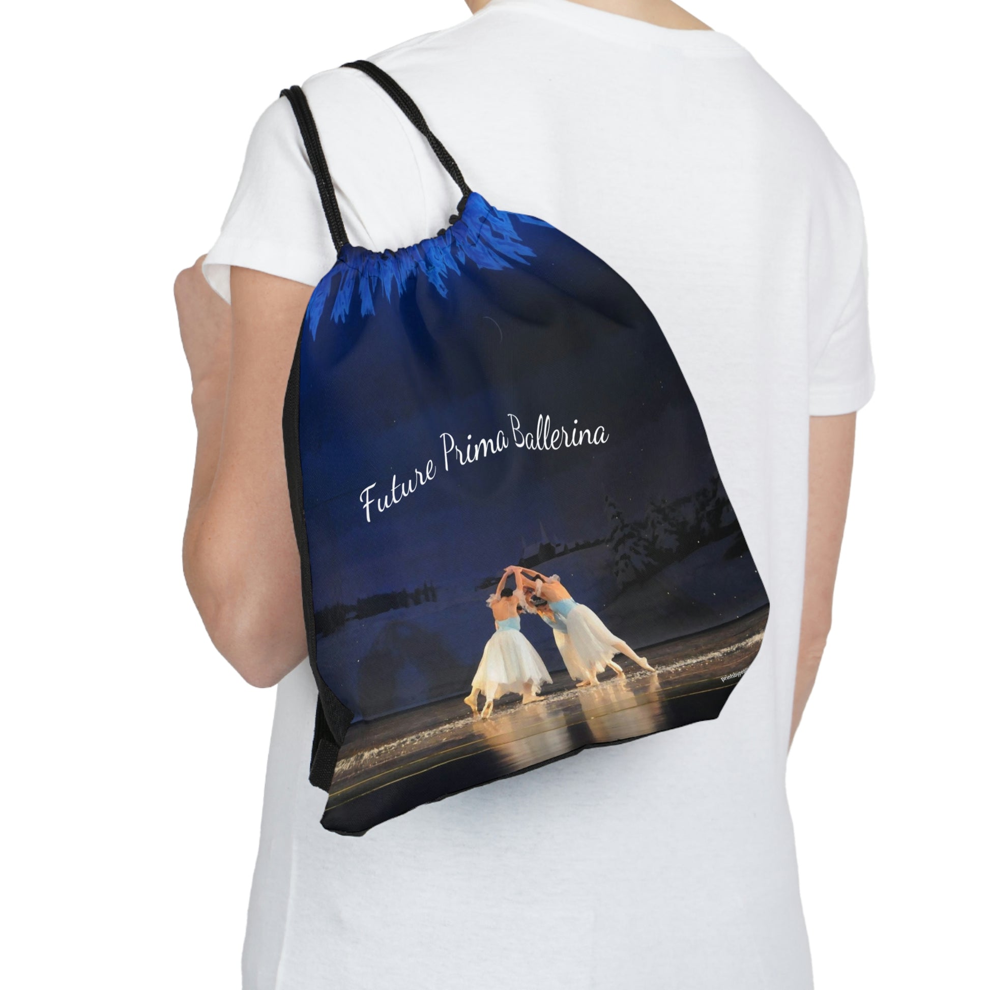 Drawstring bag showing printed side of ballerinas hanging over someone's shoulder