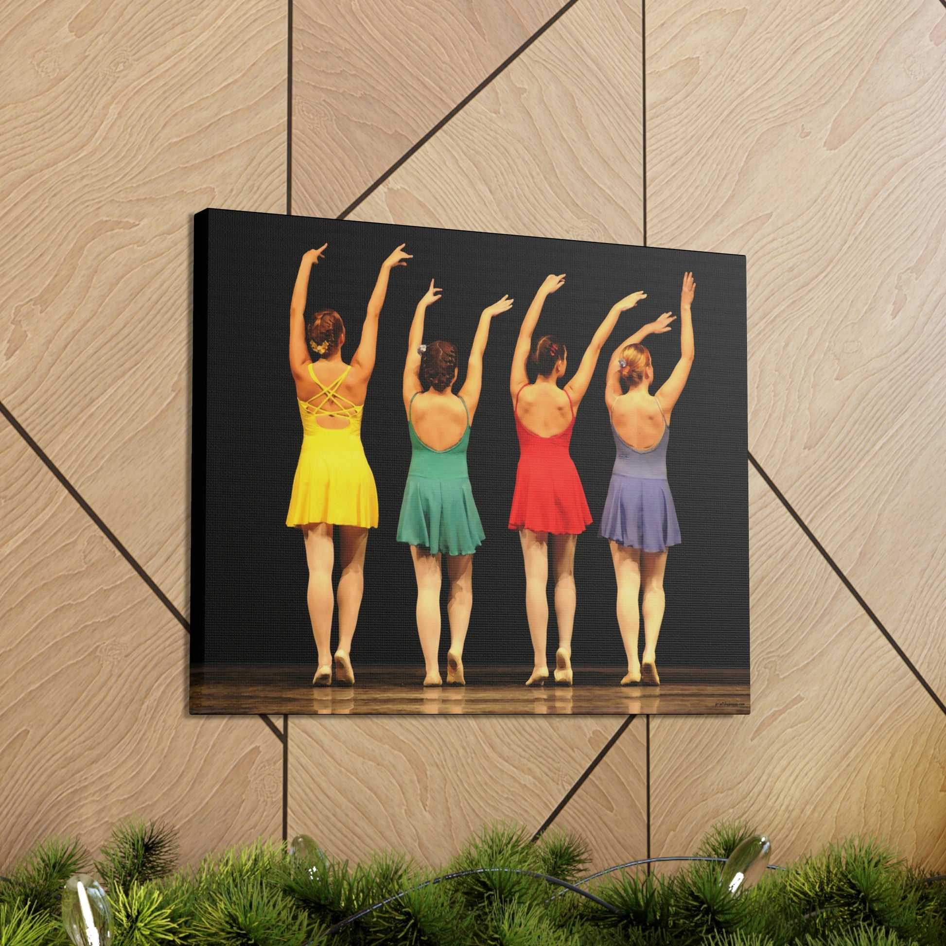 Art image hanging on the wall in a home setting of a painting of four modern dancers from the rear on stage in bright costumes