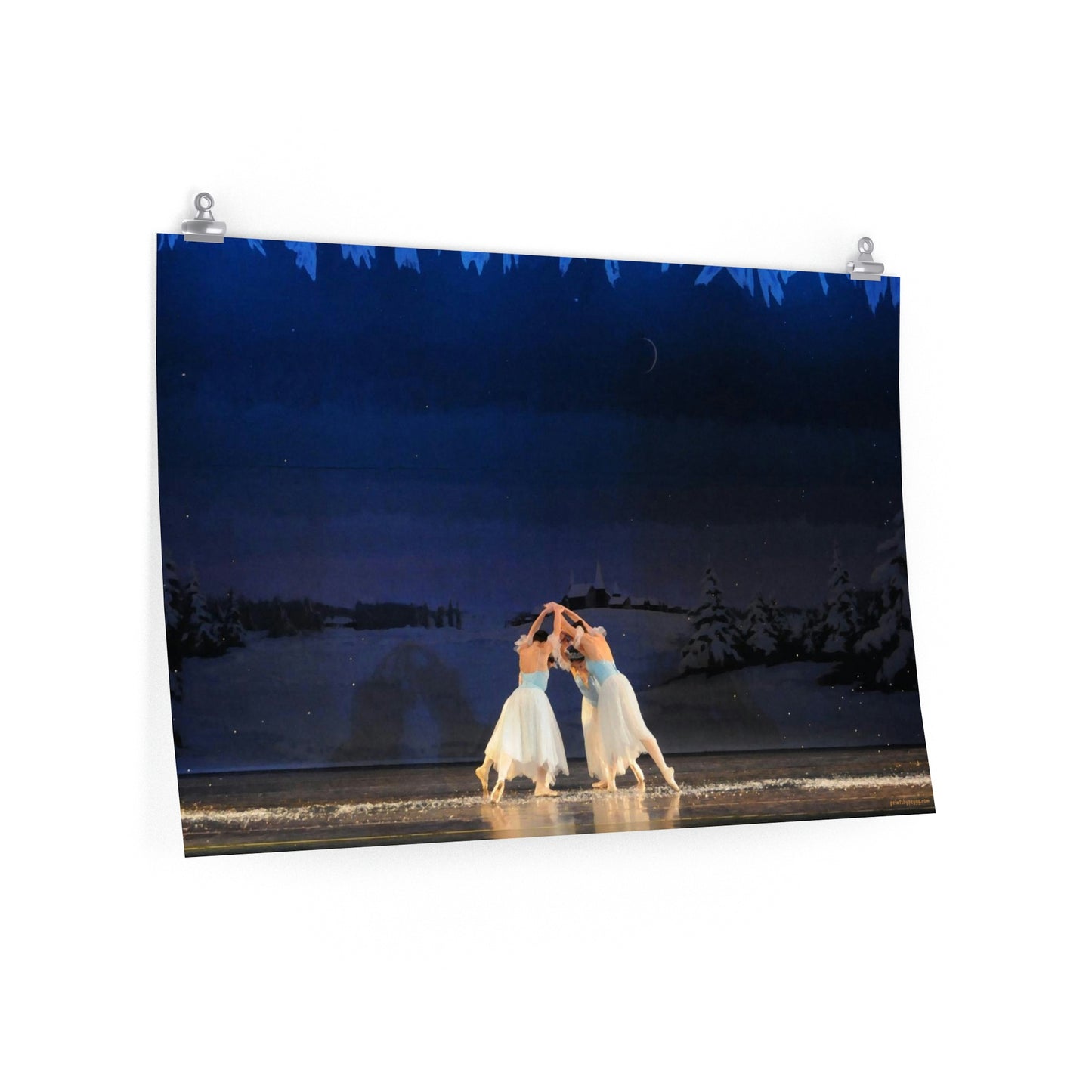 female ballet dancers in blue in a circle with a light background