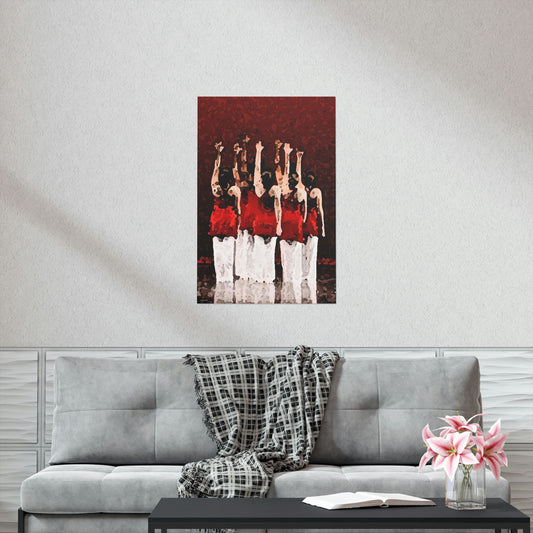Poster hanging on a wall in a livingroom setting of seven modern dancers pictured from the rear with one hand outstretched wearing red and white costumes on stage with a red back drop