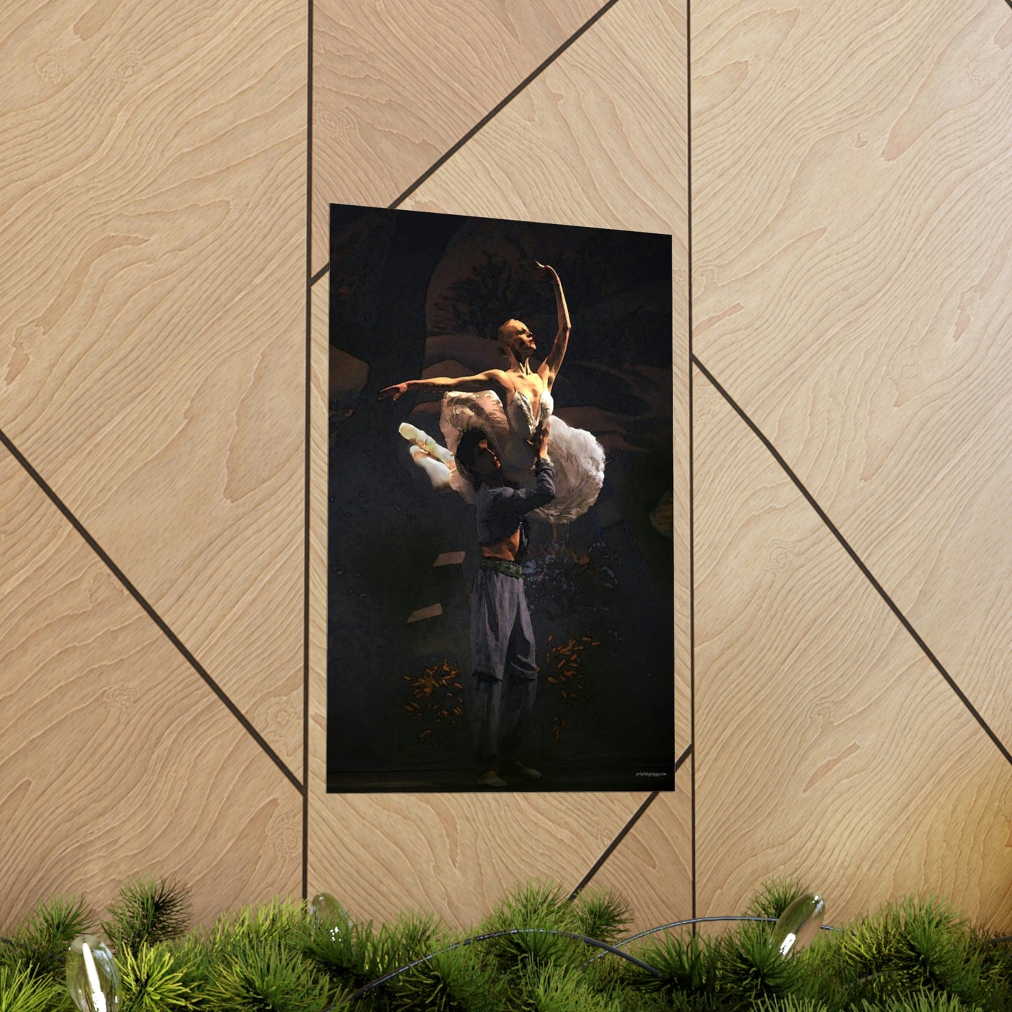 Prima Ballerina dressed in a white tutu being held in a dramatic aerial pose by a male dancer with a black background.