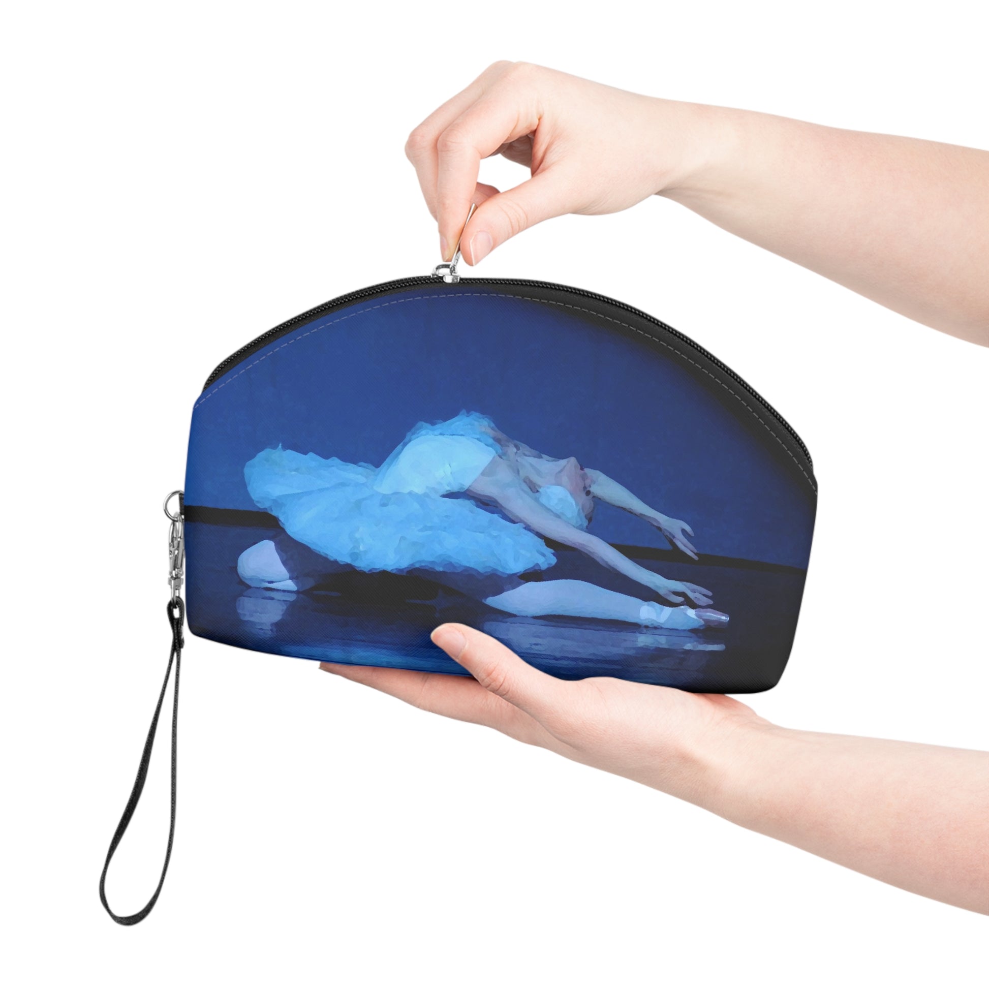 Prima ballerina performing the dying swan dressed in a white tutu bathed in blue light on a black background on a makeup bag.  