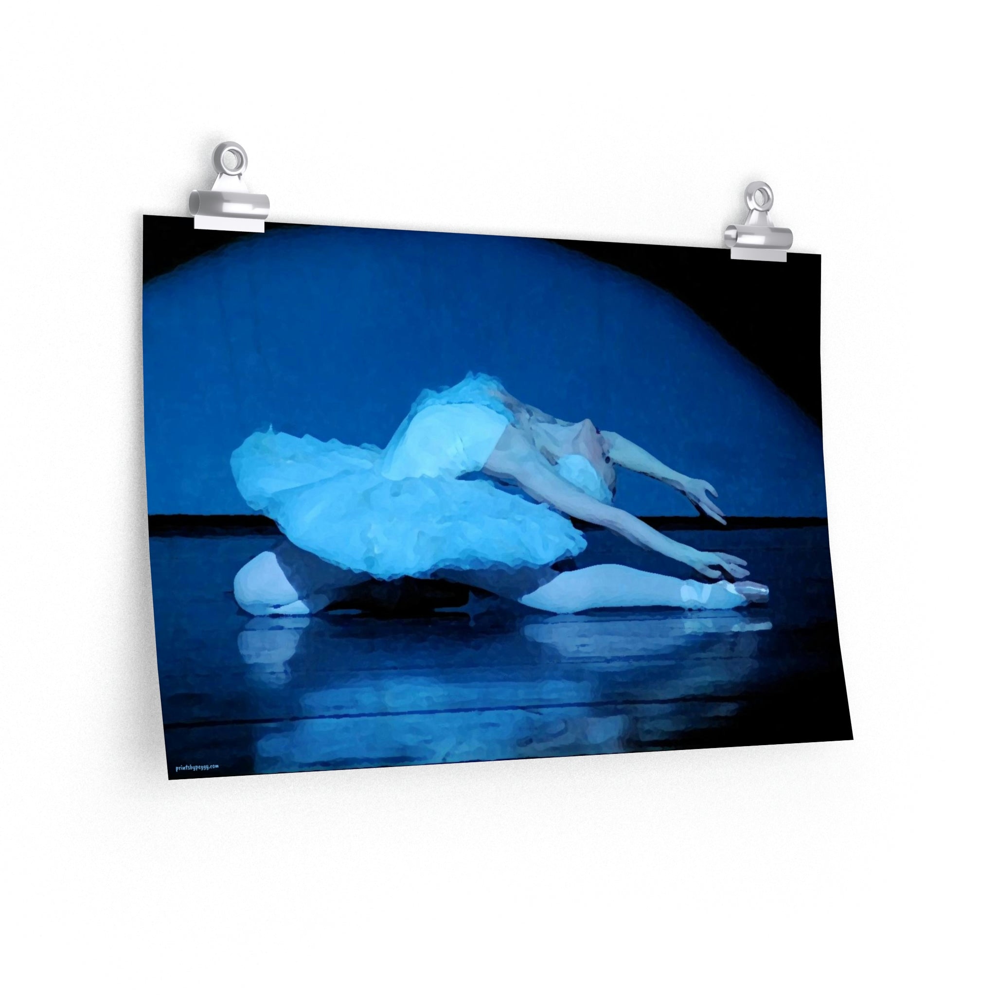 Prima Ballerina performing the dying swan in a white tutu with a blue light cast on the subject, dark background