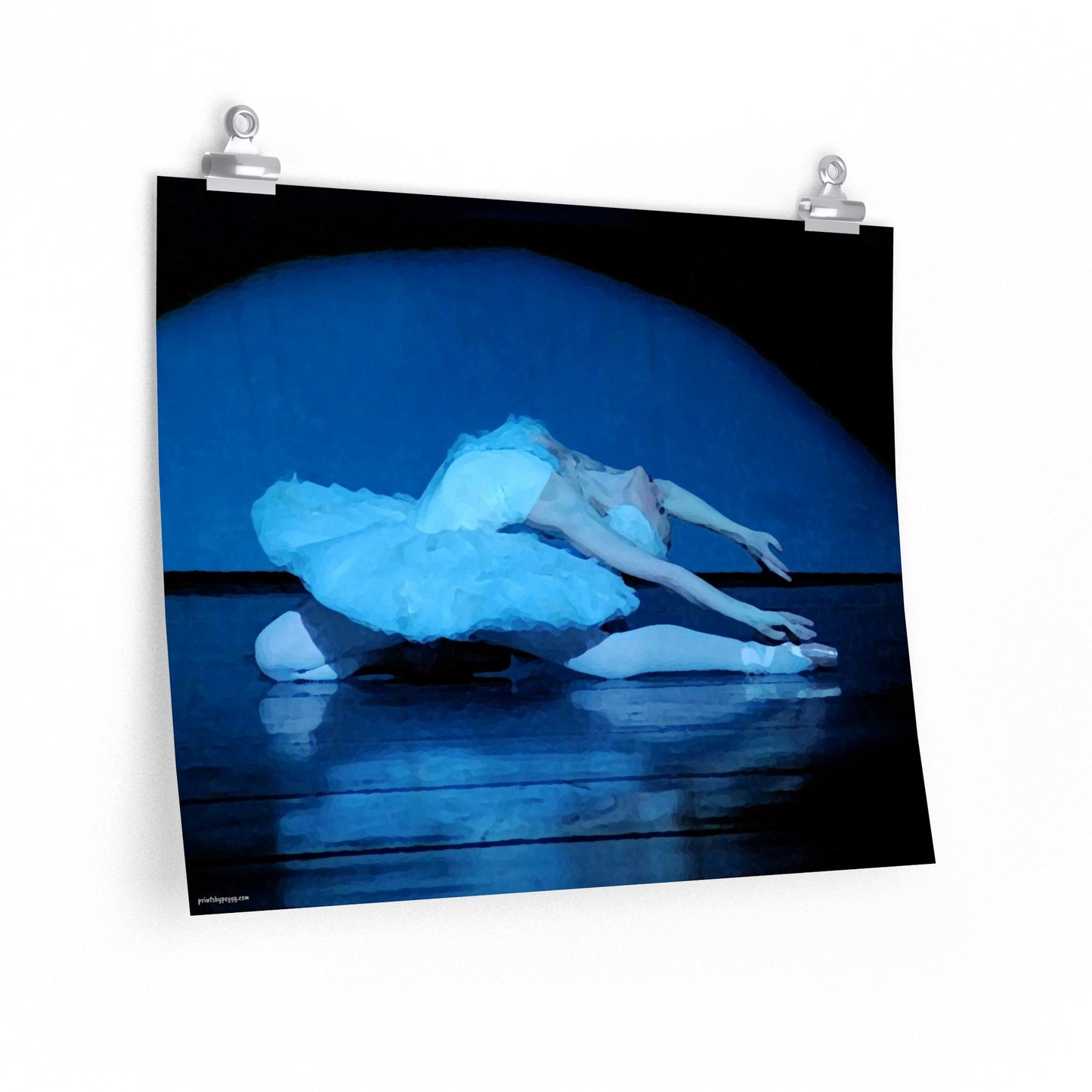 Prima Ballerina performing the dying swan in a white tutu with a blue light cast on the subject, dark background