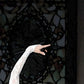 detail section of the painting of the ballerina's hand and backdrop