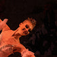detail section of 1 dancer's face and background