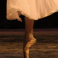detail section of the ballet slipper and white dress