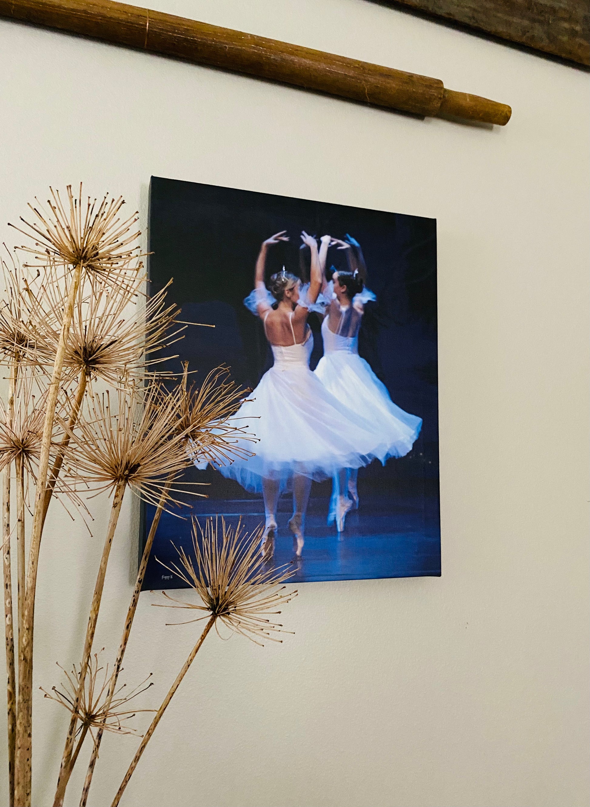 a photo of a painting of graceful ballerinas in white wearing tiaras dancing on point on stage with a dark backdrop