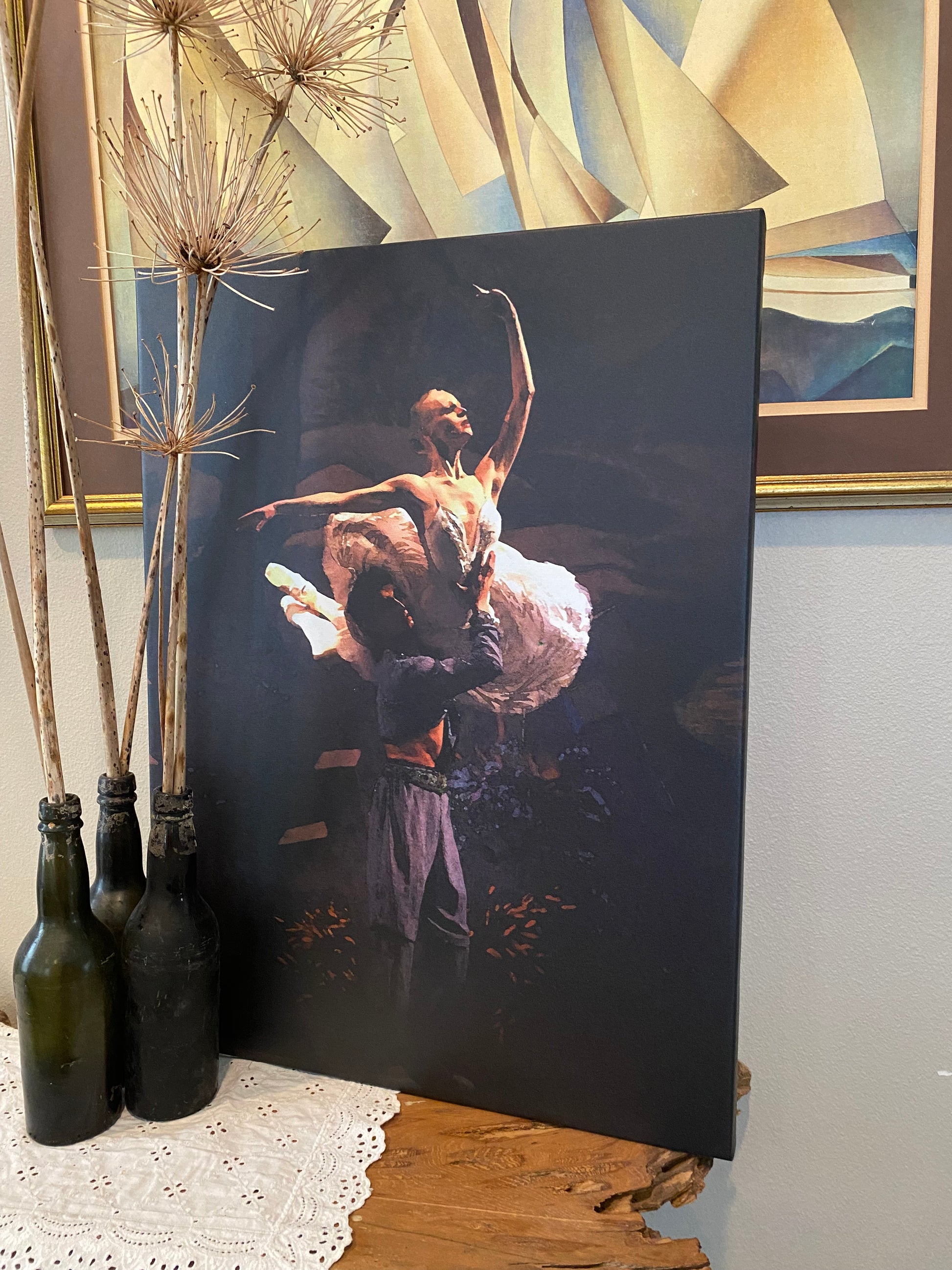 Artwork in a livingroom setting of a ballet couple in a lift position with dramatic lighting