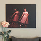 Artwork hanging on the wall of a home of two ballerinas in pink posing with wreathes of pink flowers on a dark background