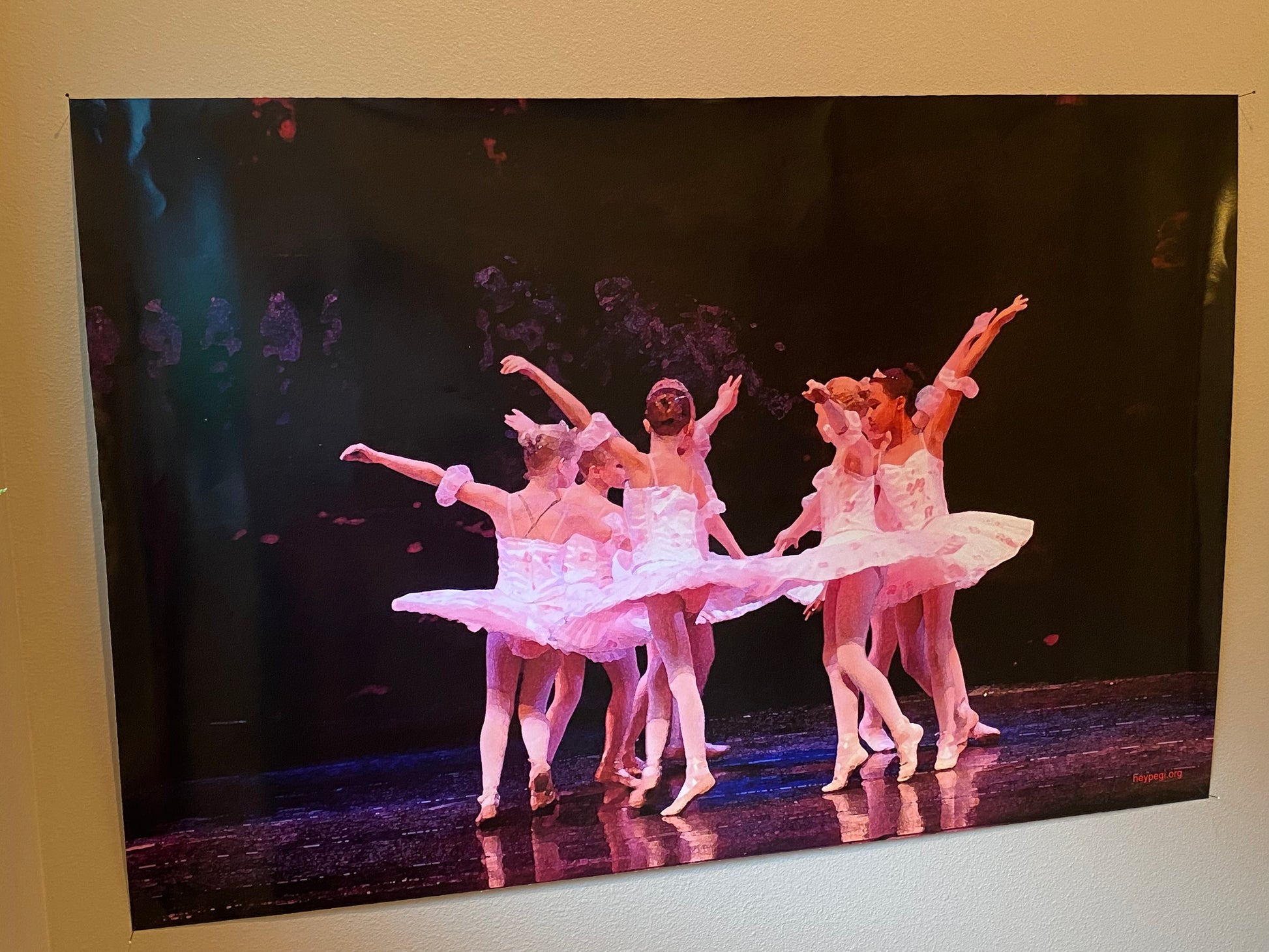 Children ballet dancers performing in a circle in pink costumes