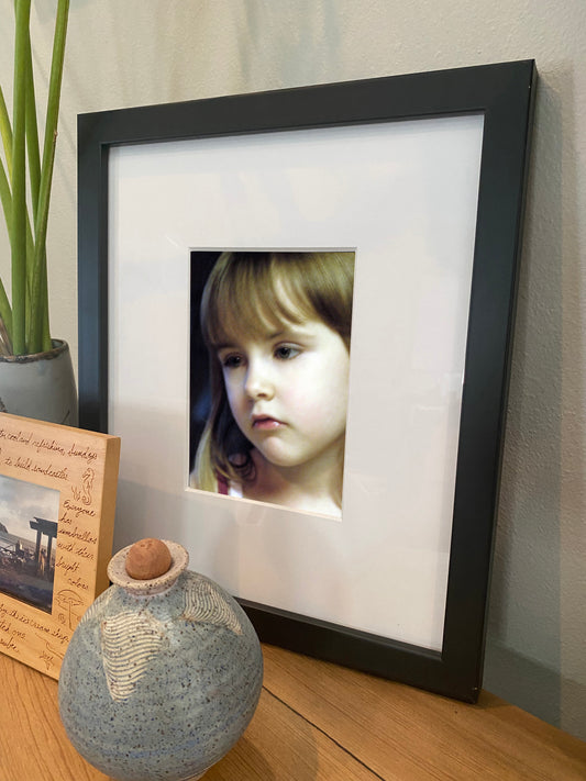 Artwork in a home setting of a beautiful child's face closeup
