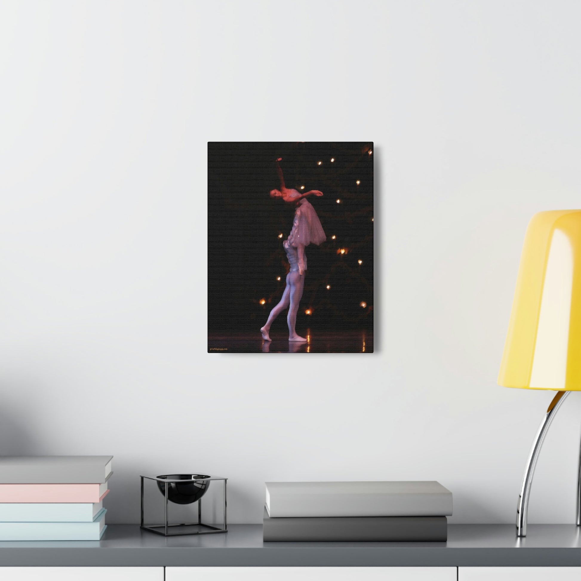 Canvas print on a wall over a desk of a Nutcracker performance with a male dancer lifting a female dancer as they exit the stage.