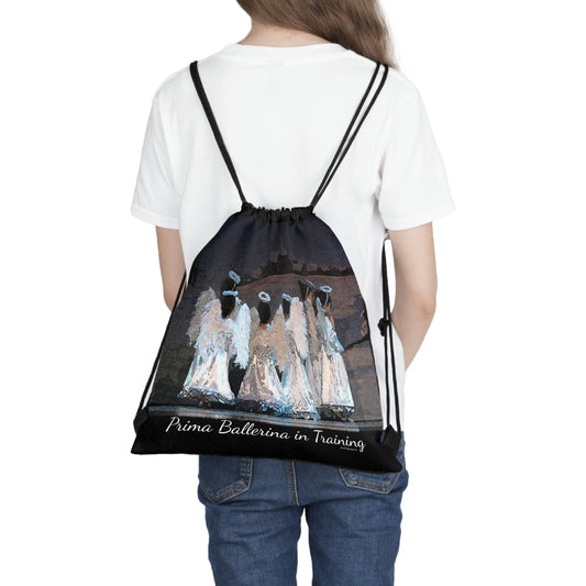 black drawstring bag with the text Prima Ballerina in Training written at the bottom with several youth dancers dressed in white as angels in the Nutcracker.