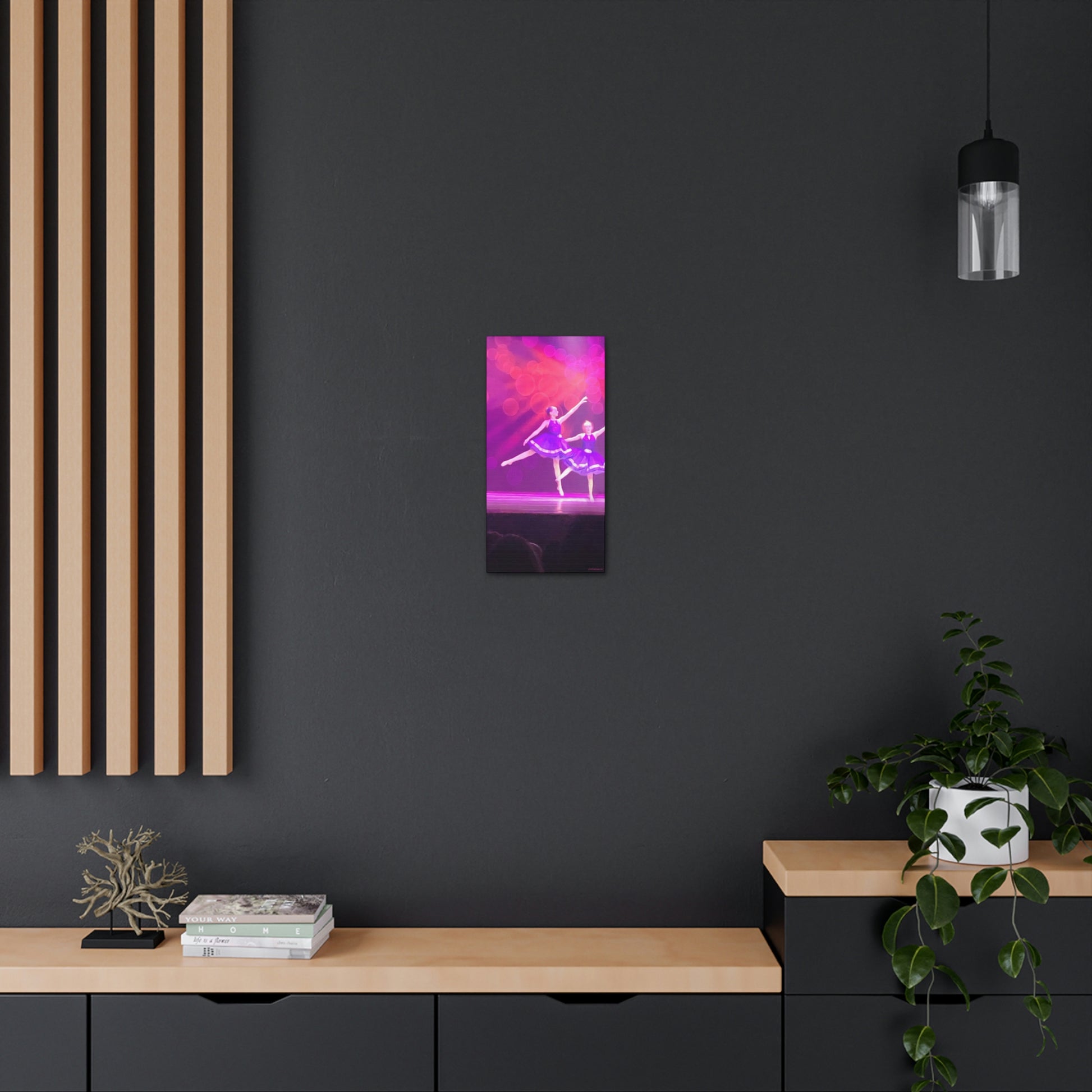 Canvas print of a Young female ballet dancer in purple hanging on a dark wall in a home setting