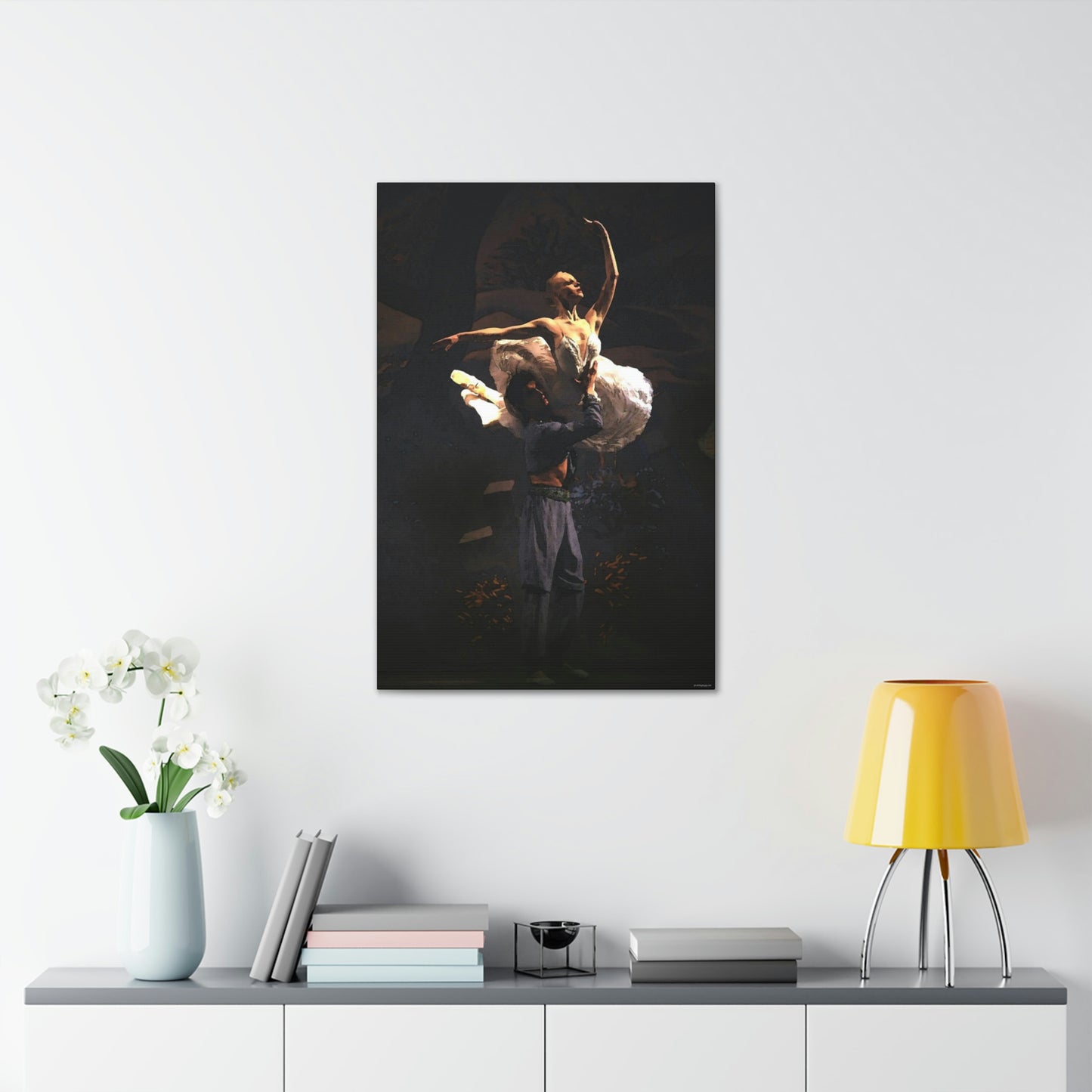 a ballet dance art painting hanging on a white wall over a desk of a couple performing on stage on a dark backdrop of him lifting her in a dramatic pose