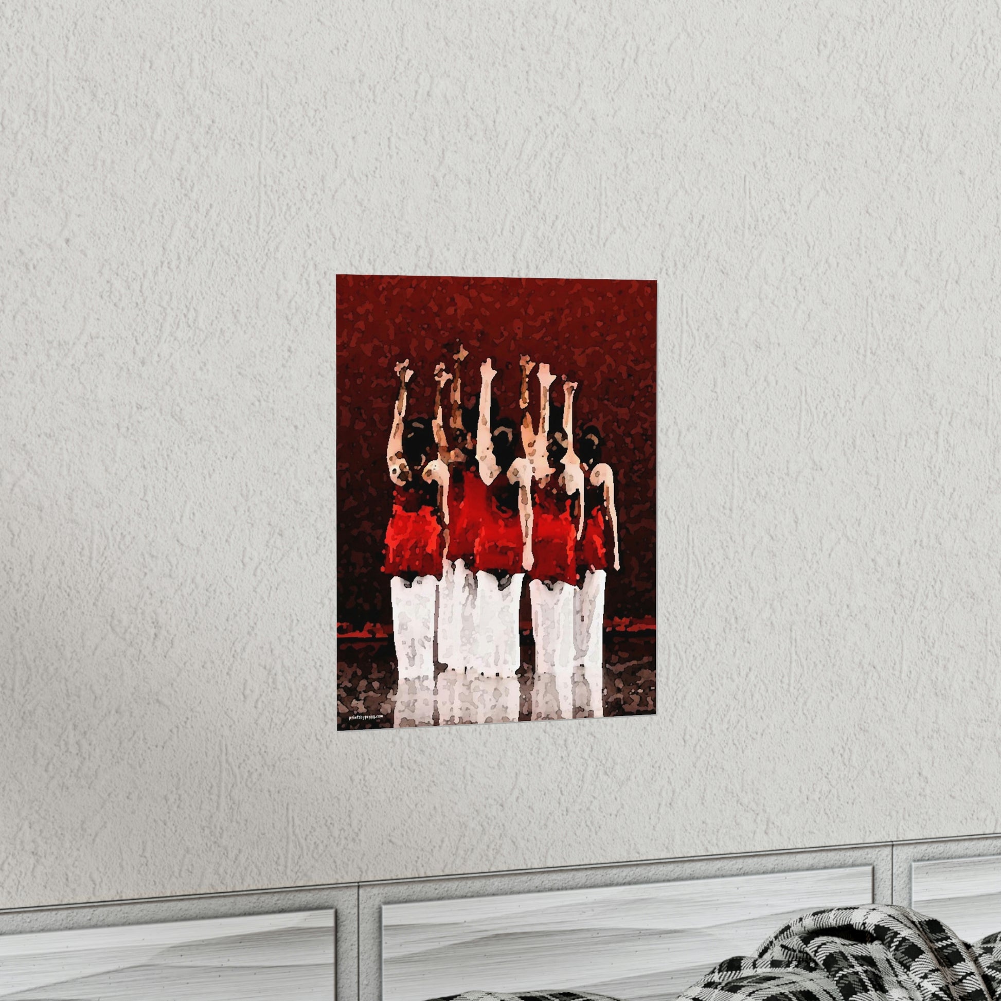 Poster hanging on a wall in a livingroom setting of seven modern dancers pictured from the rear with one hand outstretched wearing red and white costumes on stage with a red back drop