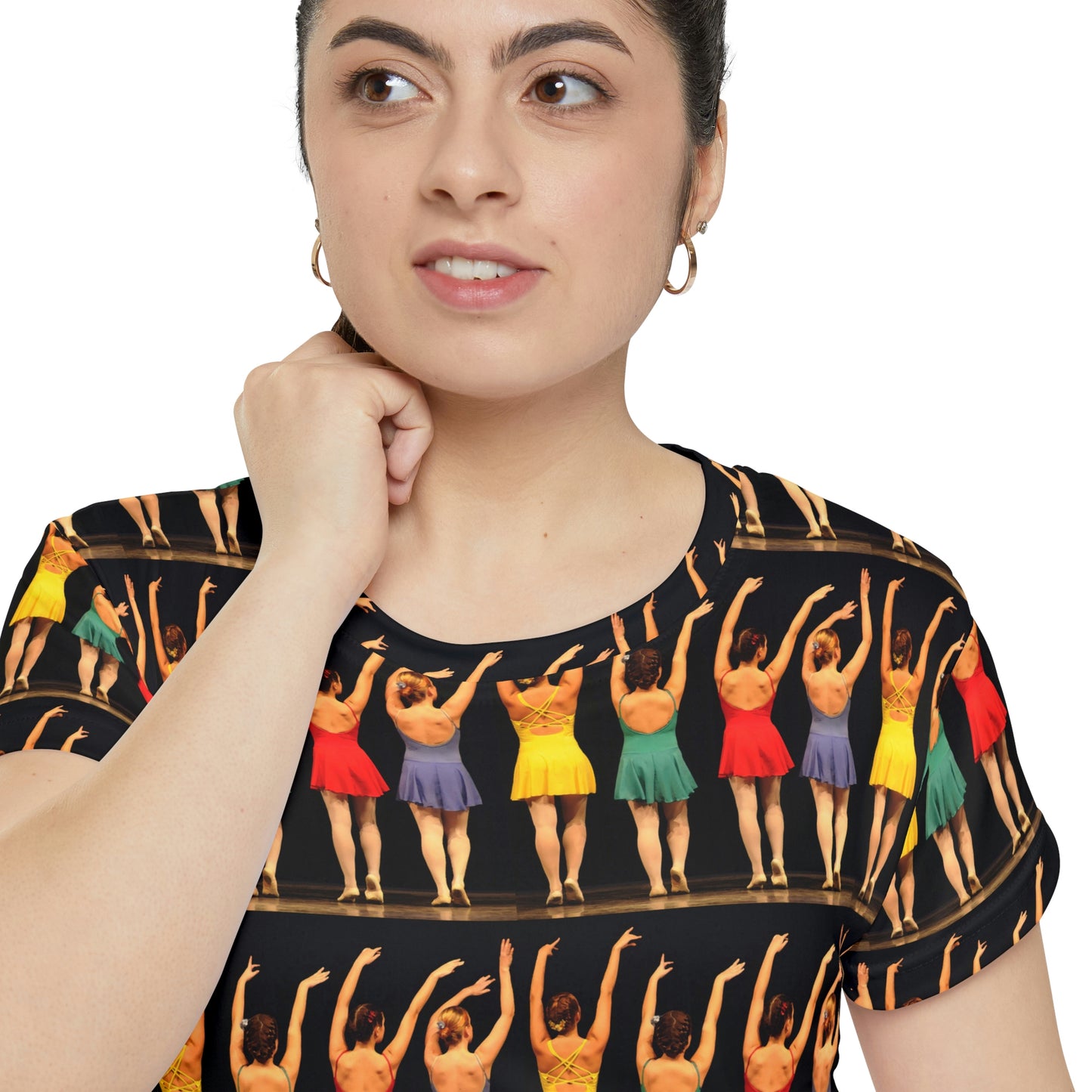 a closeup view of a model wearing a blouse or shirt with short sleeves and a neckband printed with brightly colored modern dancers pictured ffrom the rear